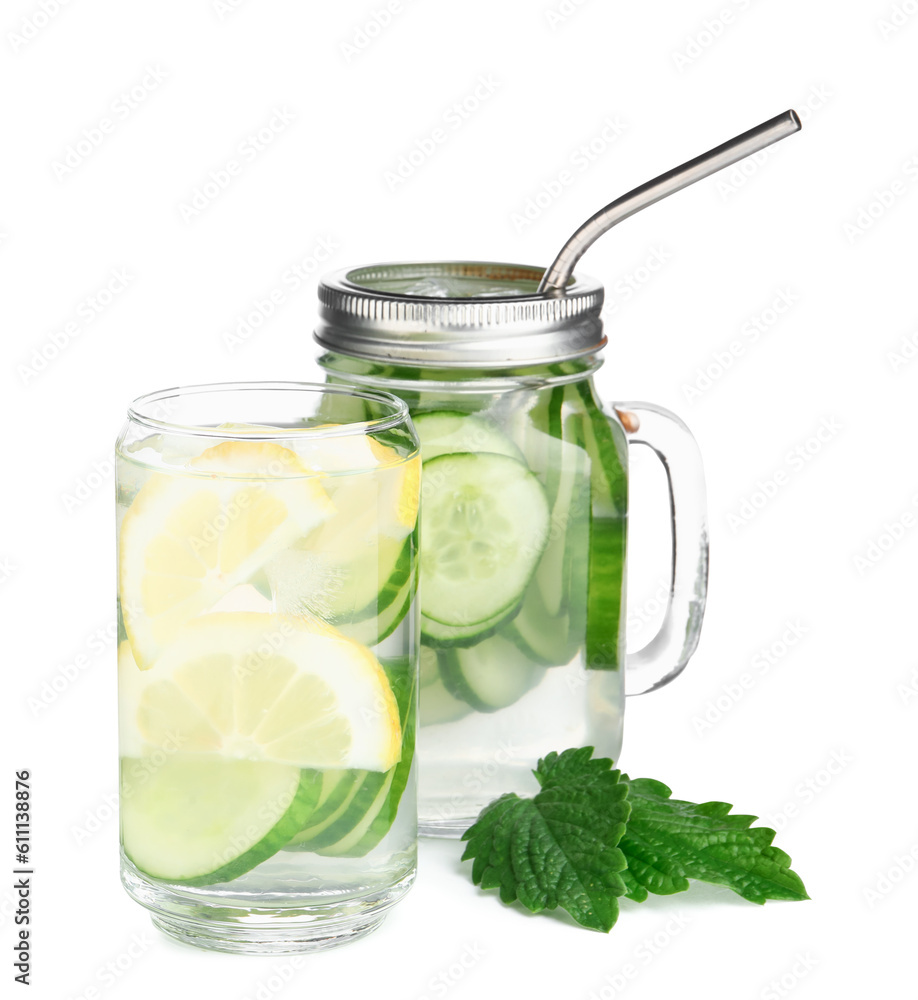 Glass and mason jar of infused water with cucumber slices on white background