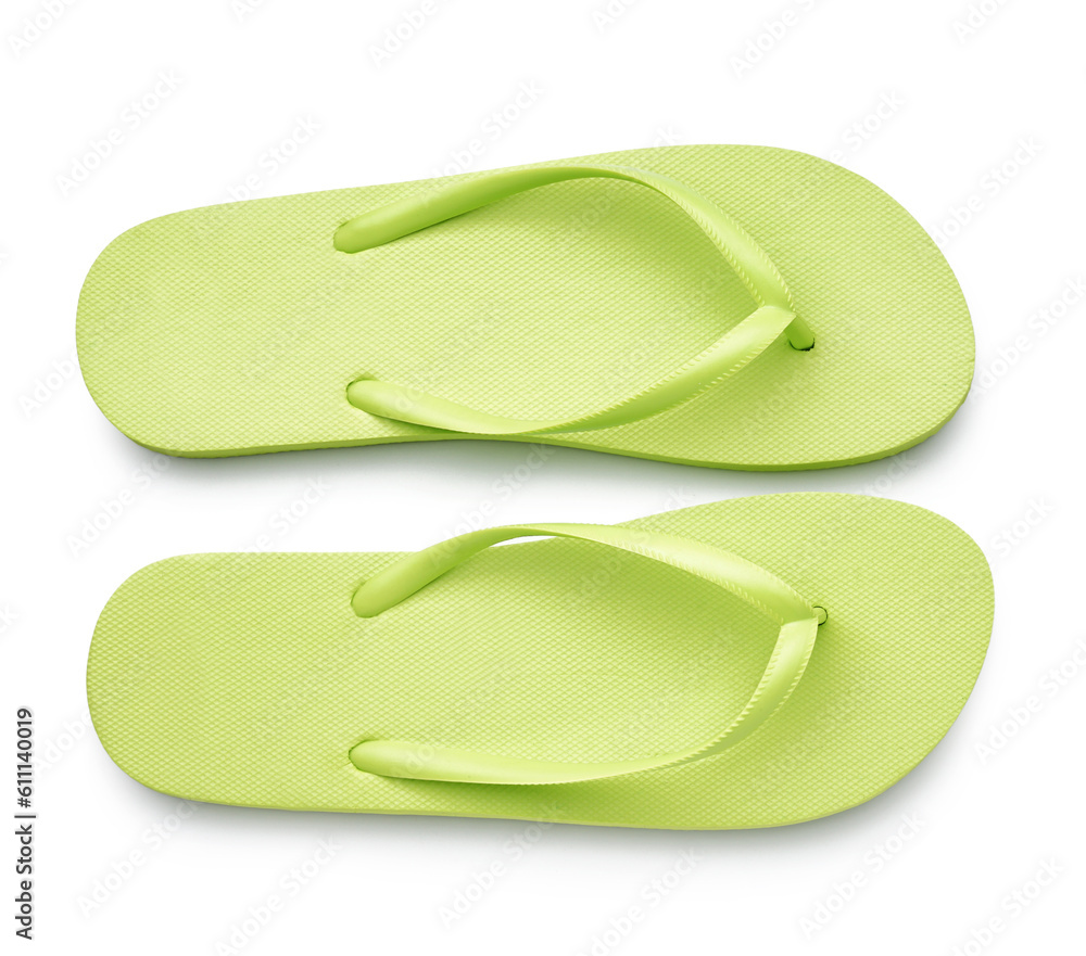 Pair of stylish green flip-flops on white background