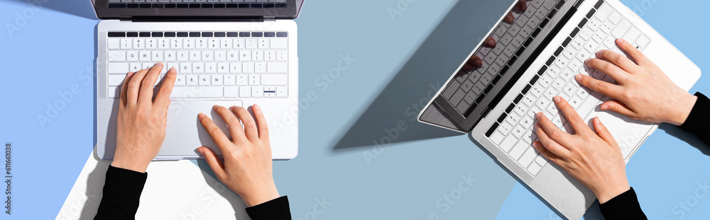 Two people working together with laptop computers