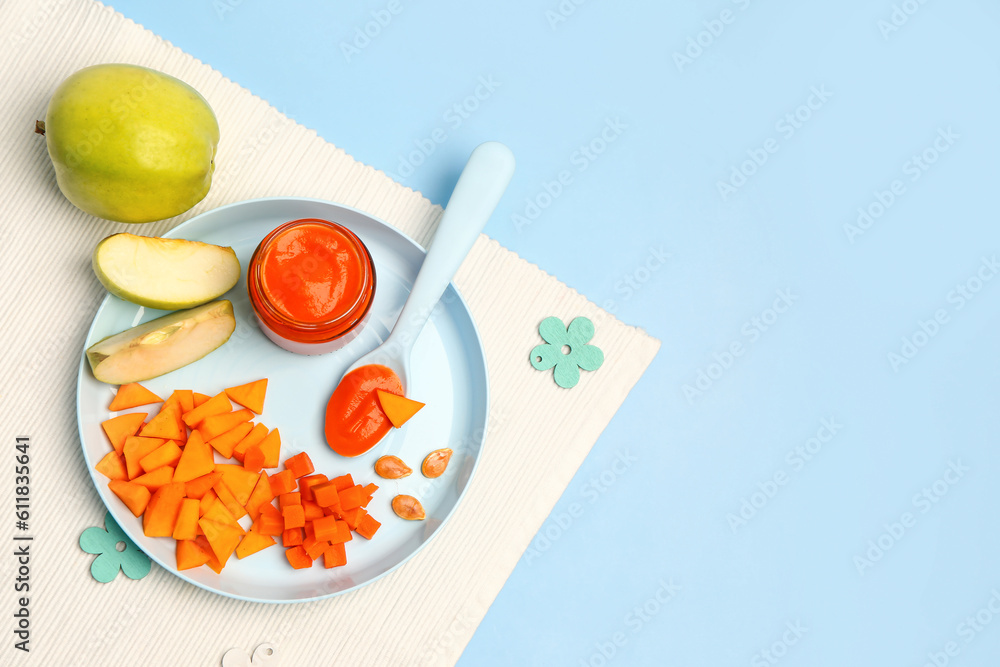 Plate with fresh apple, vegetables and jar of baby food on color background