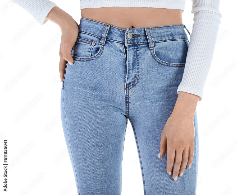 Young woman in skinny jeans on white background, closeup