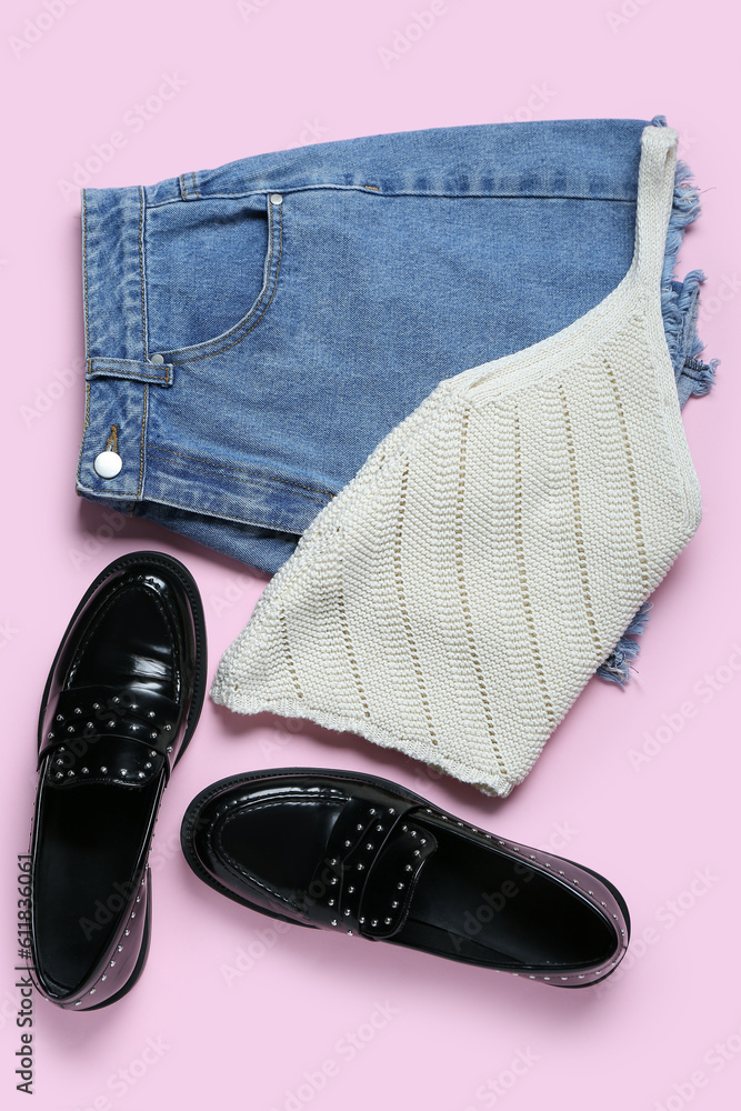 Denim shorts with top and shoes on pink background