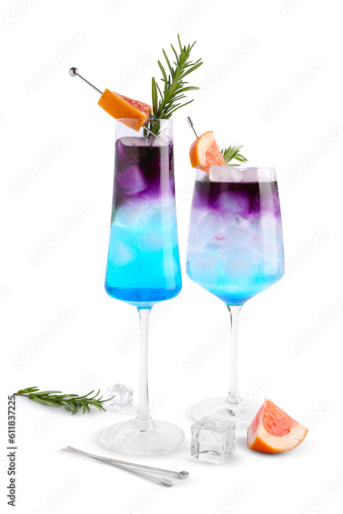 Glasses of gin and tonic with grapefruit and rosemary on white background