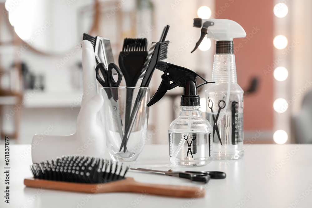 Different hairdressing tools on table in beauty salon