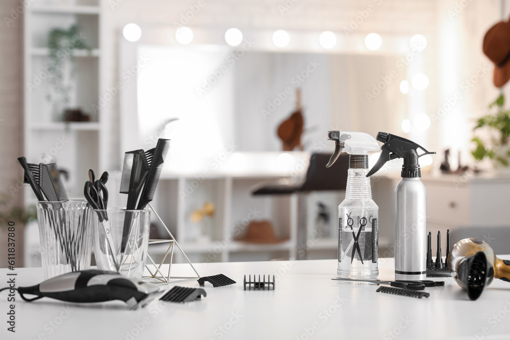 Different hairdressing tools on table in beauty salon