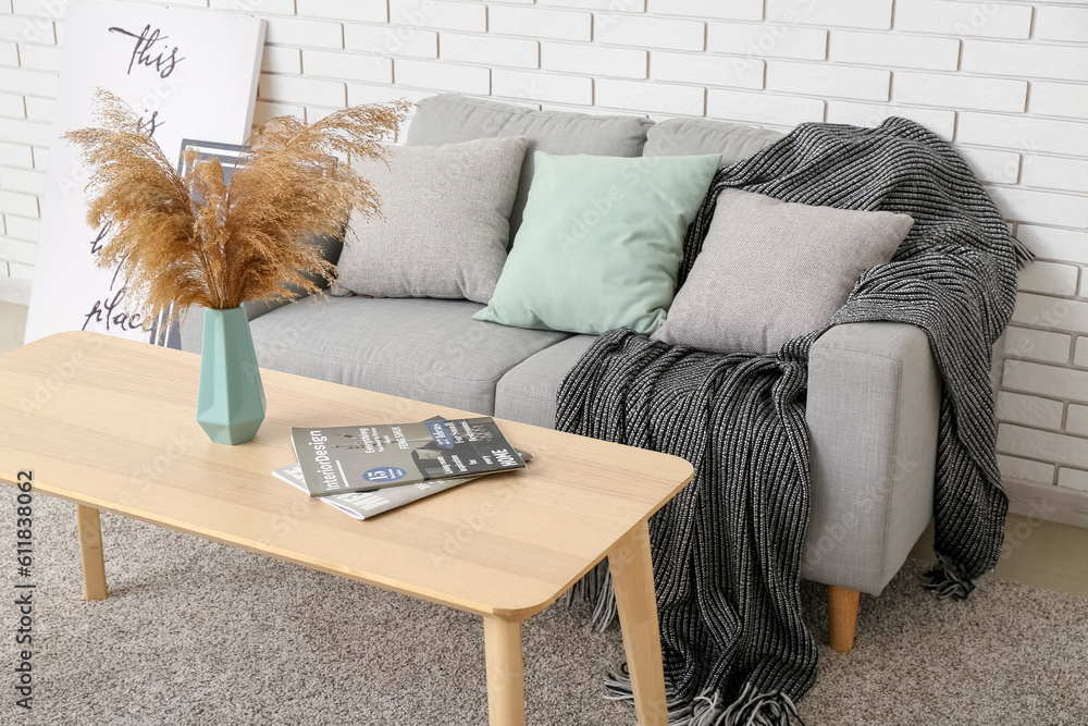 Interior of living room with sofa and vase on table