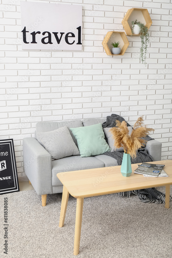 Interior of living room with sofa and vase on table