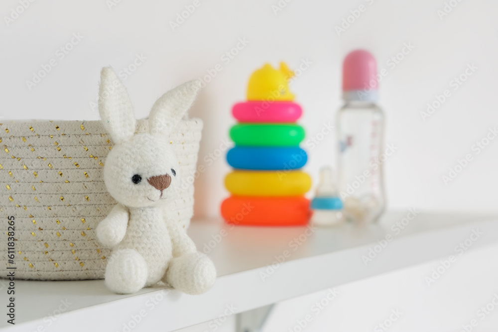 Shelves with different toys in childrens room, closeup