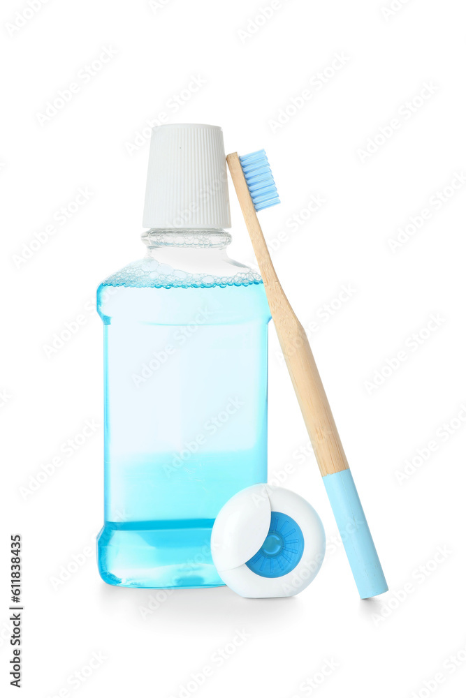 Dental floss, toothbrush and mouthwash isolated on white background