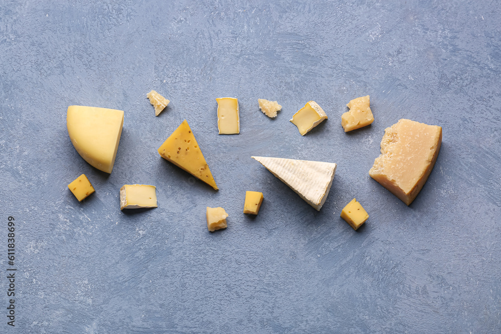 Pieces of tasty cheese on grey background