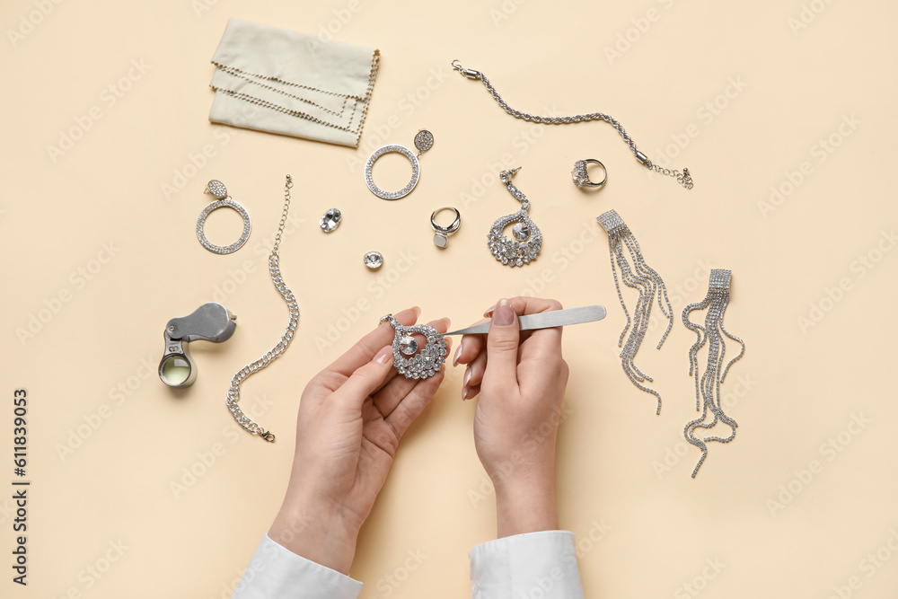 Woman cleaning stylish accessories on color background