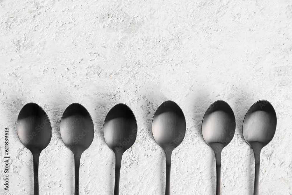 Stainless steel spoons on white background