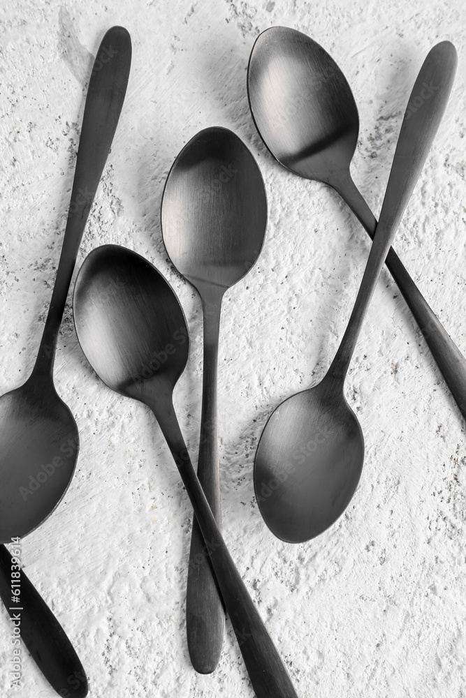 Stainless steel spoons on white background