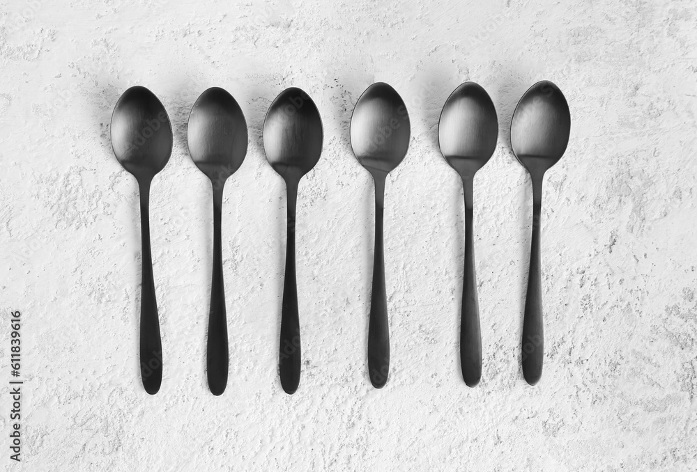 Stainless steel spoons on white background