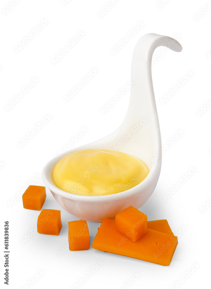 Bowl with tasty cheddar sauce and slices of cheese on white background