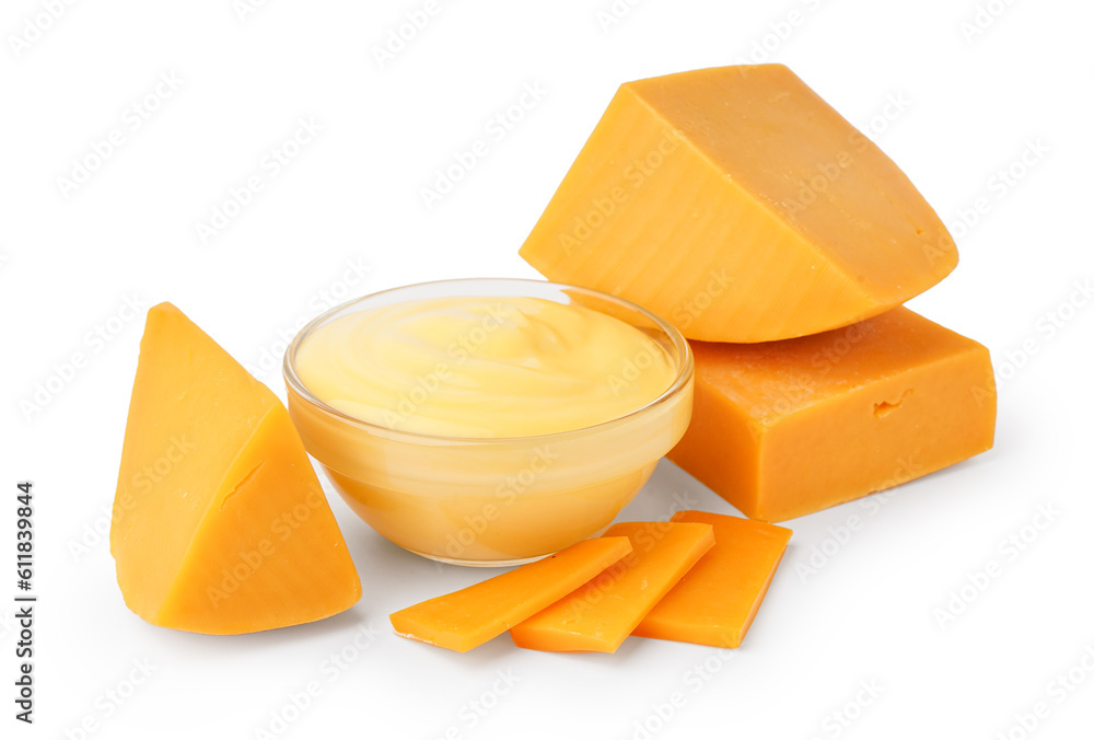 Bowl with tasty cheddar sauce and chunks of cheese on white background