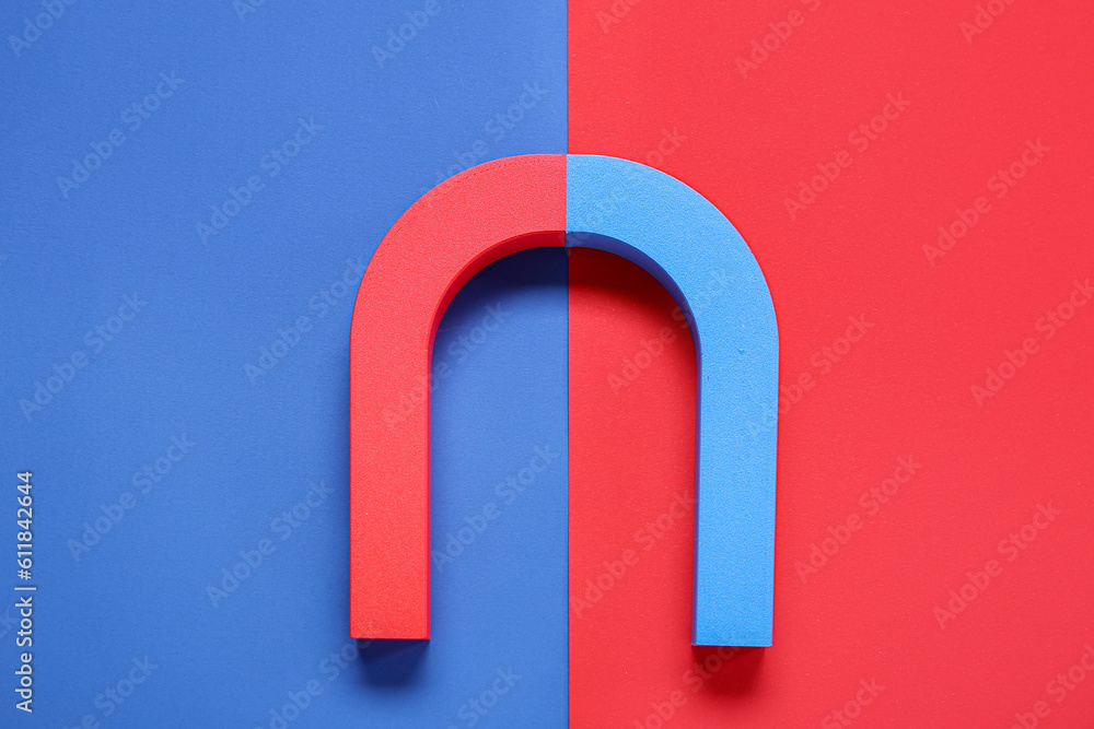 Horseshoe shaped magnet on color background