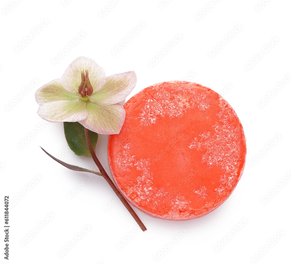 Red solid shampoo bar with flower on white background