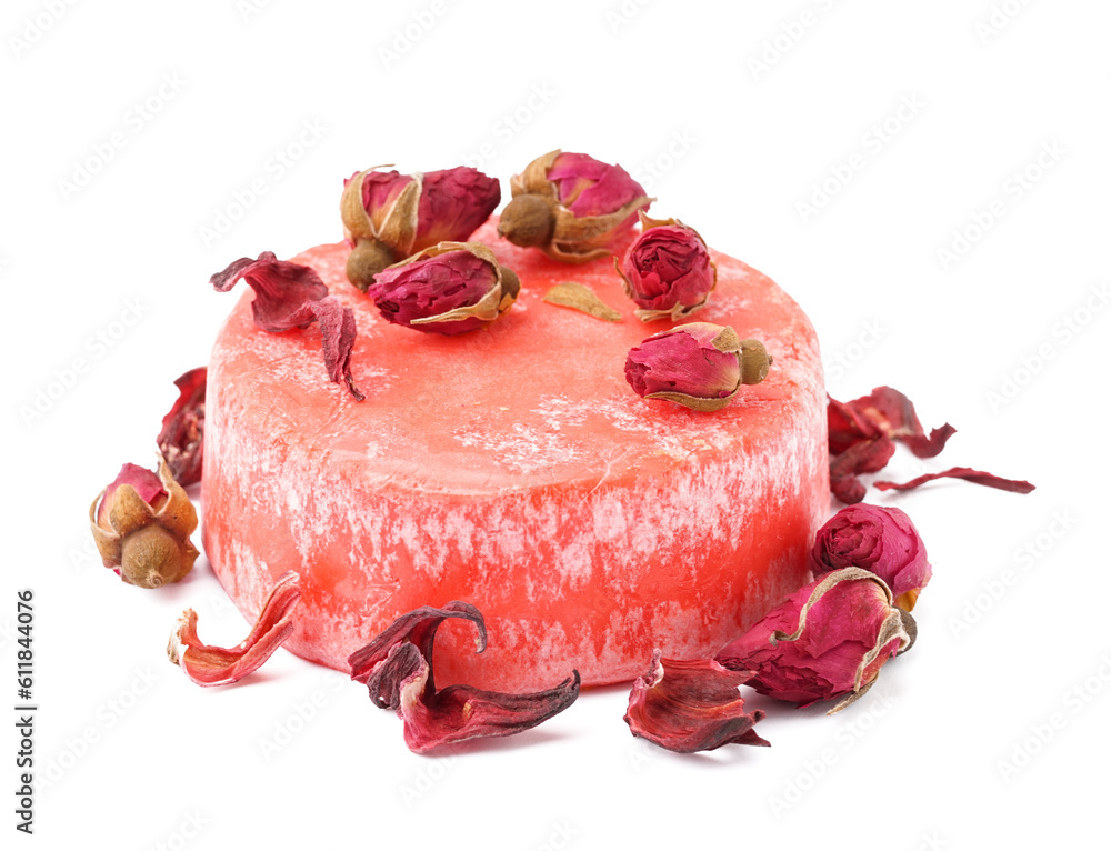 Red solid shampoo bar with dry roses on white background