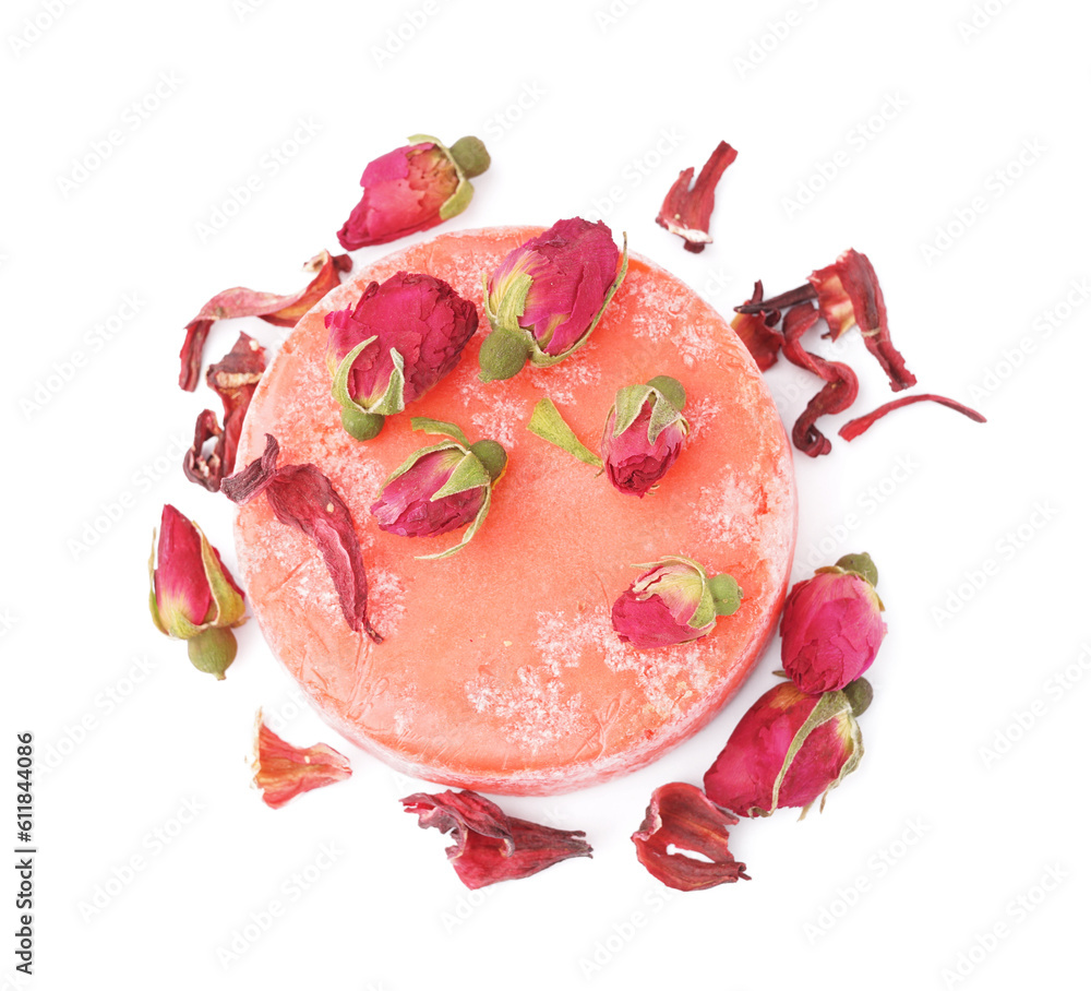 Red solid shampoo bar with dry roses on white background