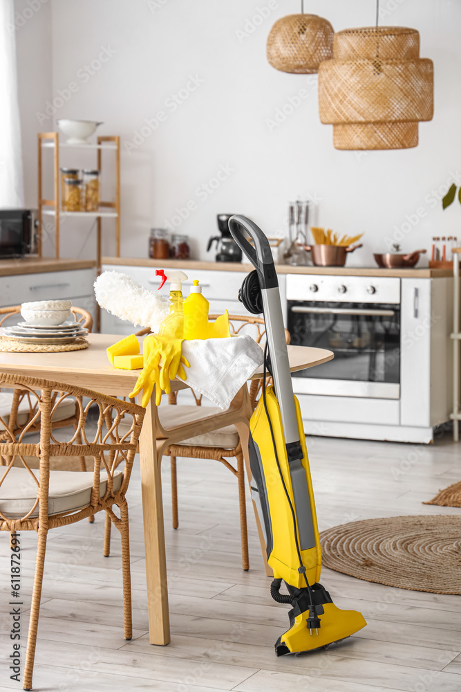 Cleaning supplies on dining table in kitchen