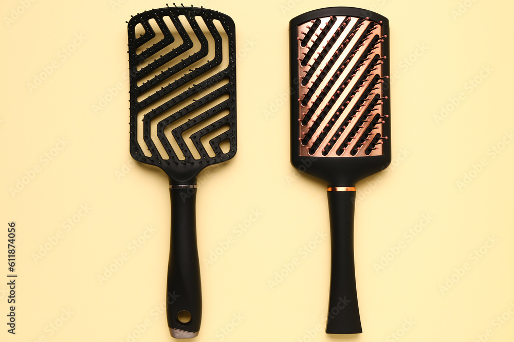 Hairdressers brushes on yellow background