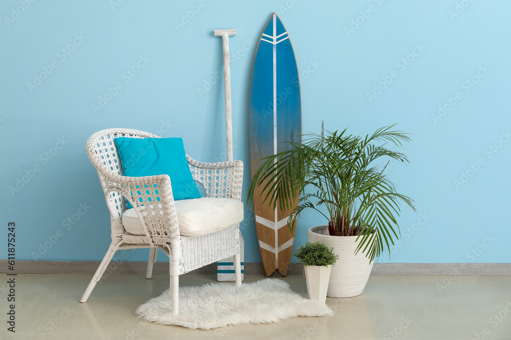 Interior of living room with surfboard, paddle and armchair