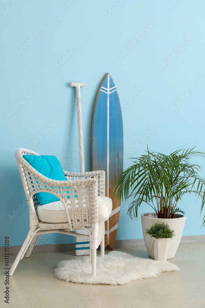 Interior of living room with surfboard, paddle and armchair