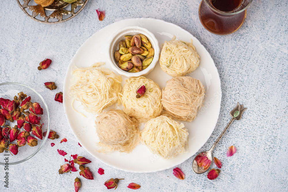 Plate with tasty Turkish Pismaniye on light background