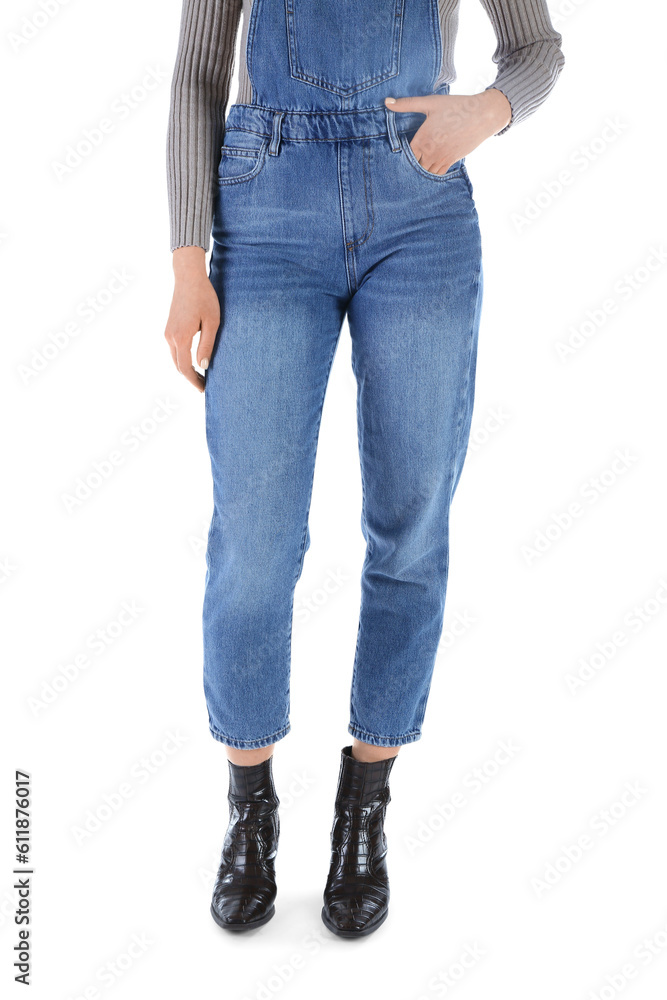 Young woman in denim jumpsuit on white background