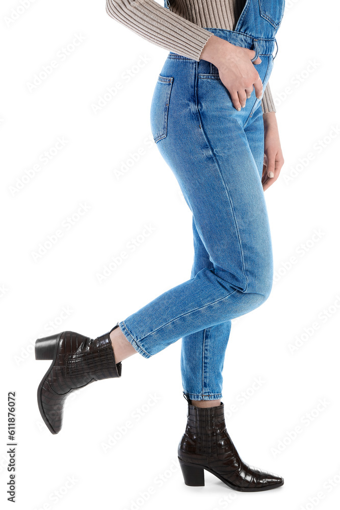 Young woman in denim jumpsuit on white background