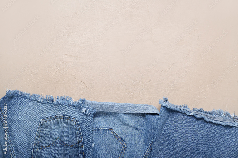 Denim shorts on beige background