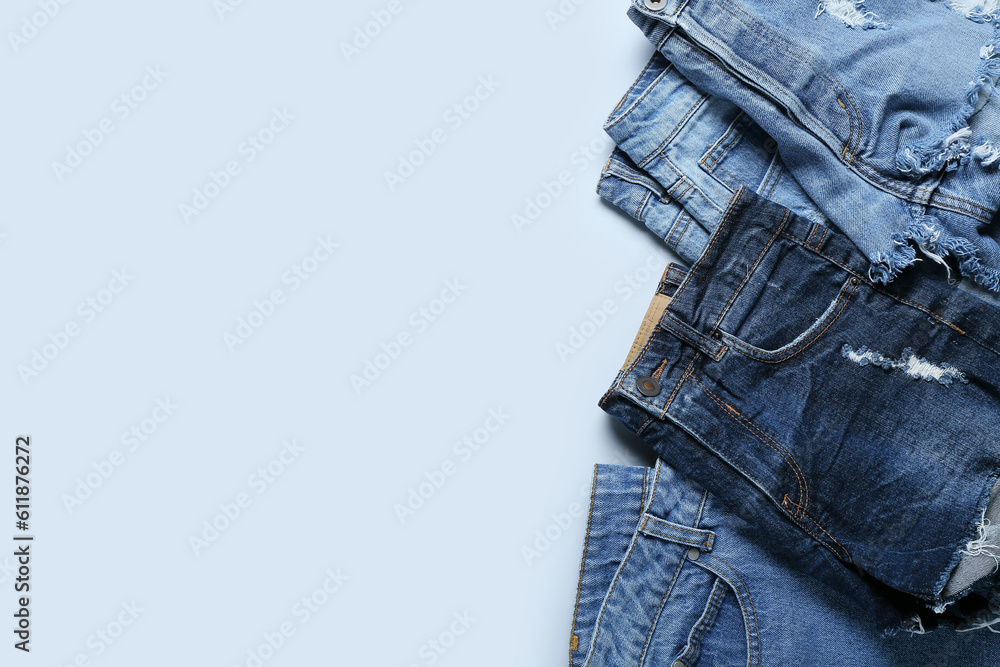 Stylish jeans on light background