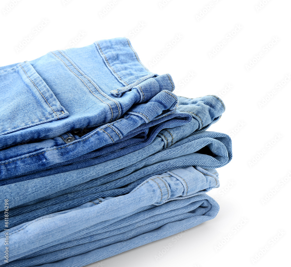 Stack of jeans on white background, closeup