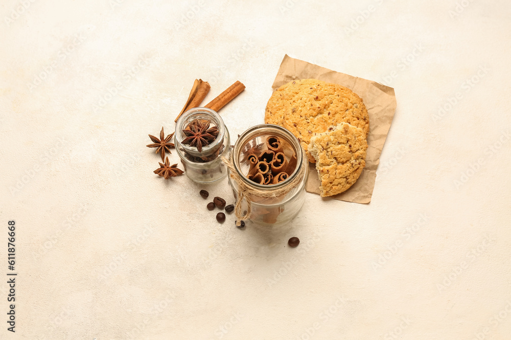 Composition with cinnamon sticks, anise stars and tasty cookies on light background