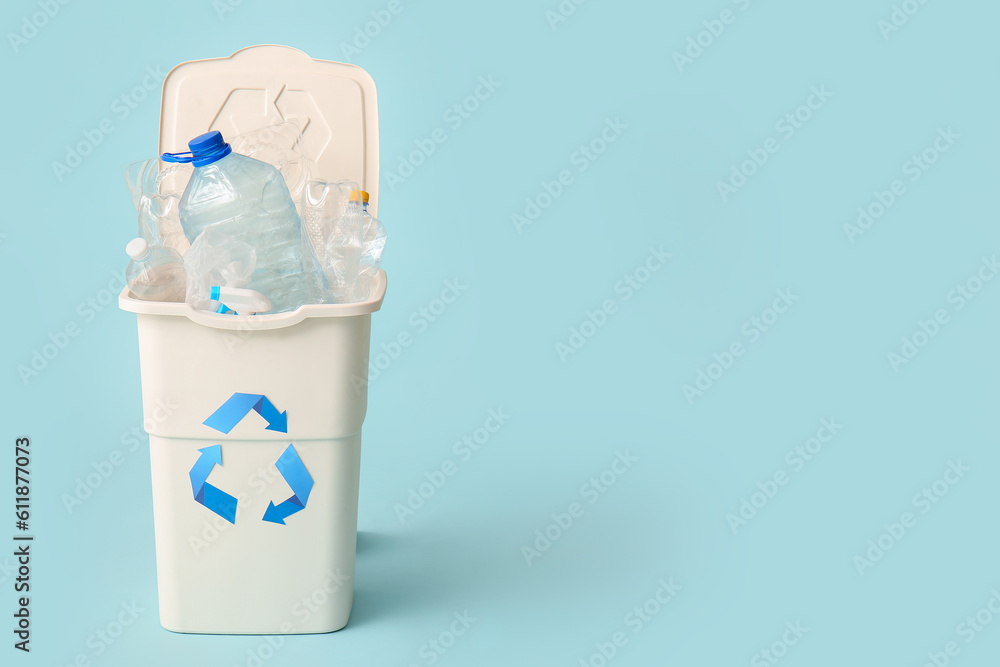 Container for garbage with plastic on light blue background. Recycling concept