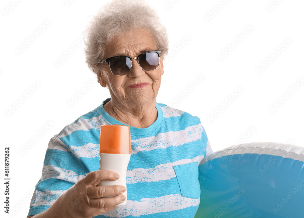 Senior woman with sunscreen cream and inflatable ring on white background, closeup