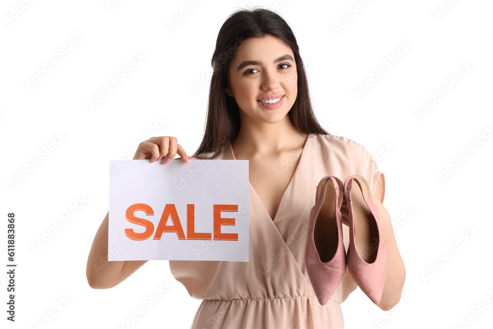 Female seller with sale sign and stylish shoes on white background