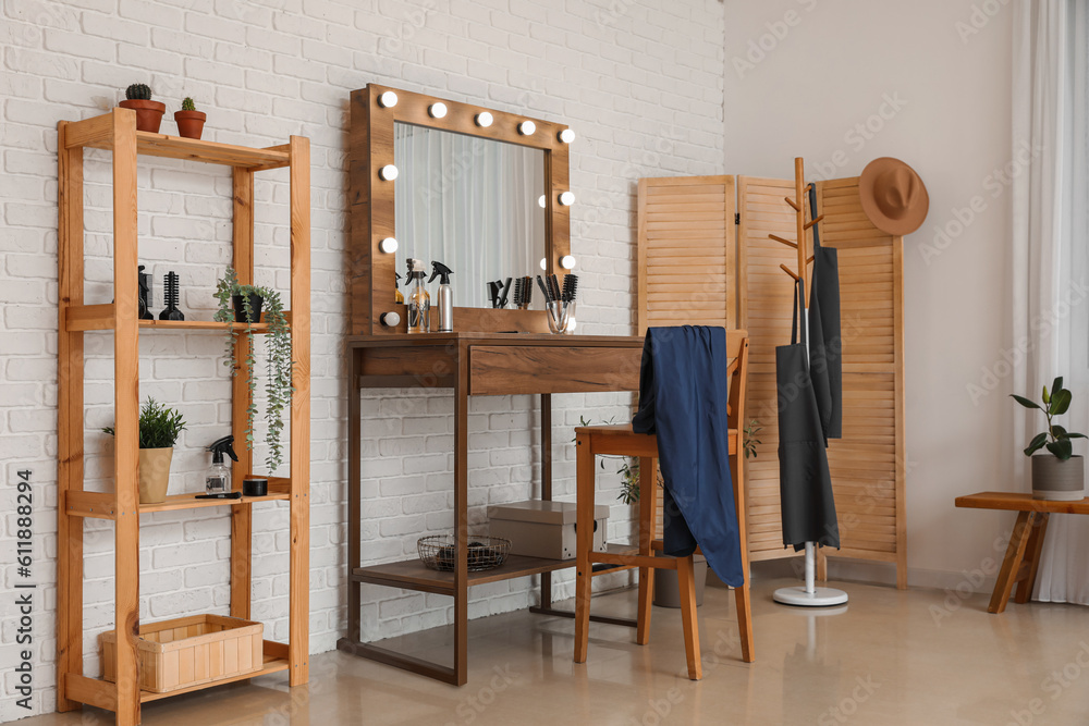 Interior of beauty salon with stylish table and folding screen