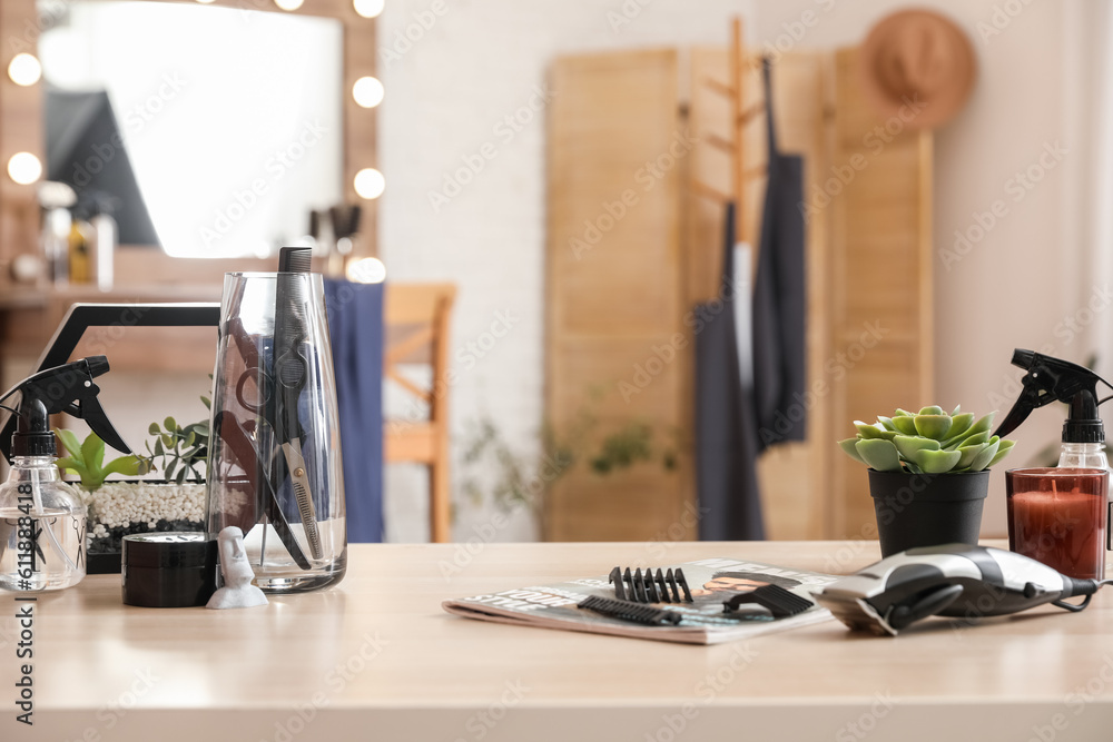 Different hairdressing tools on table in beauty salon