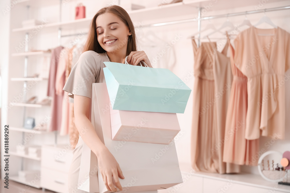 Young woman with shopping bags in boutique