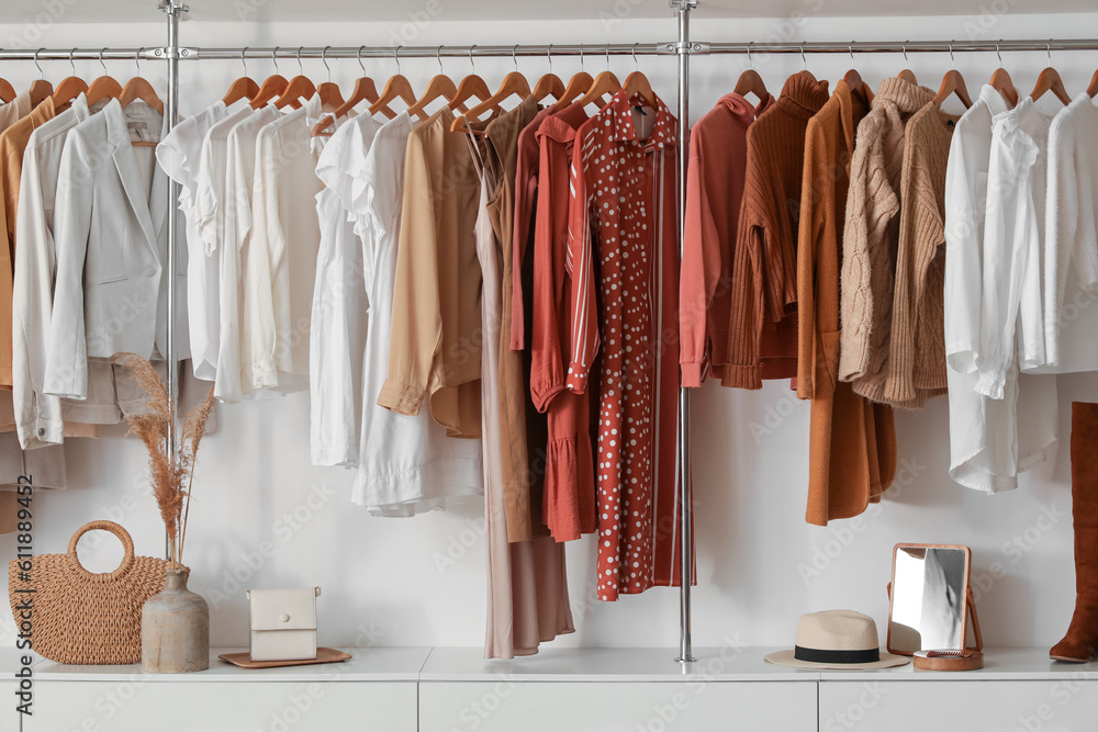 Stylish female clothes hanging in boutique