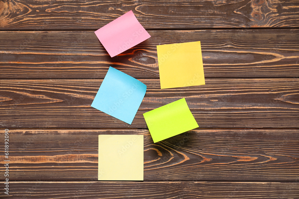 Sticky notes on brown wooden background