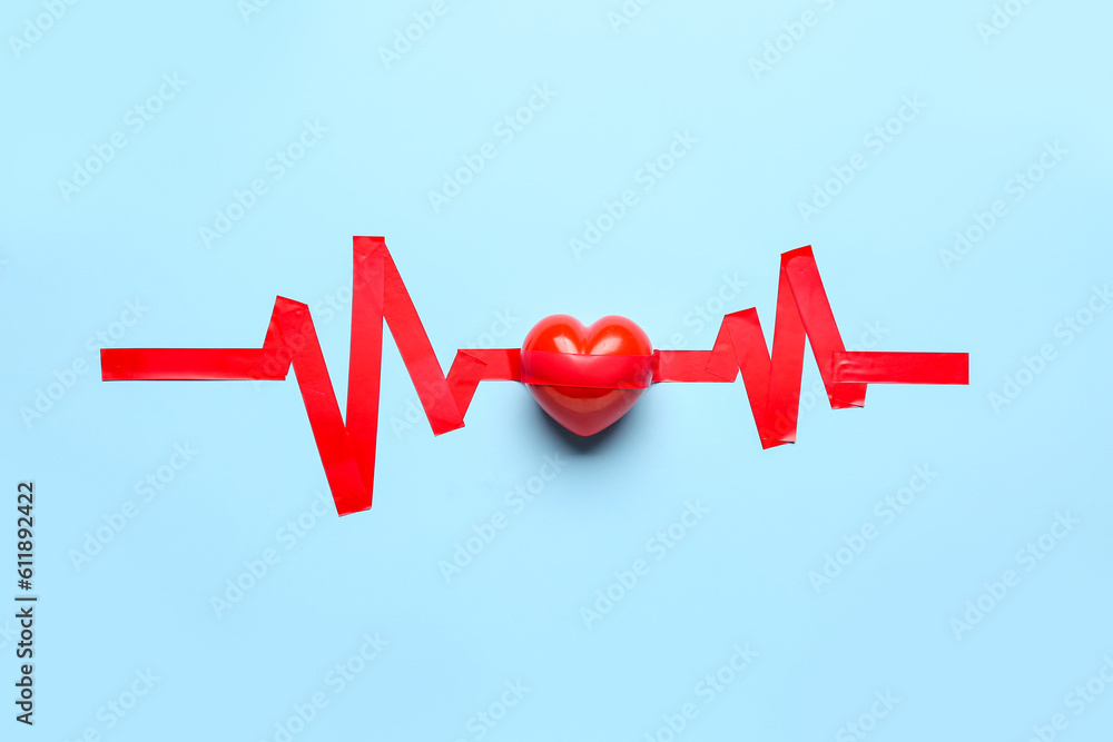 Heart with cardiogram made of adhesive tape on blue background