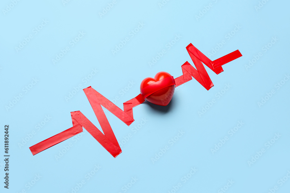 Heart with cardiogram made of adhesive tape on blue background