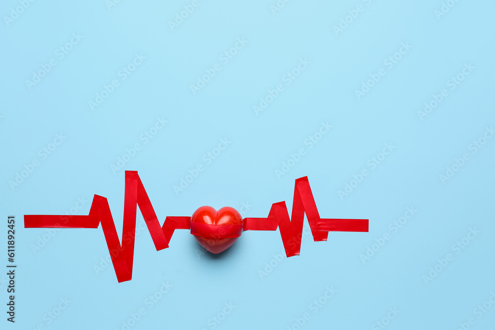 Heart with cardiogram made of adhesive tape on blue background