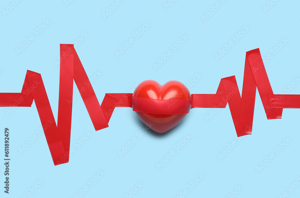 Heart with cardiogram made of adhesive tape on blue background