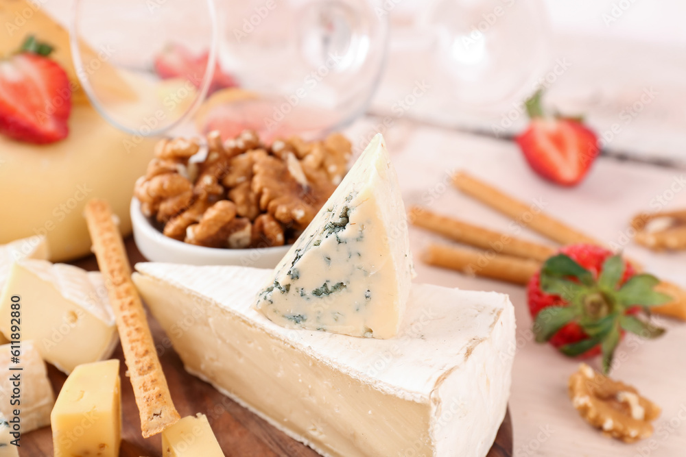 Different types of tasty cheese on table, closeup