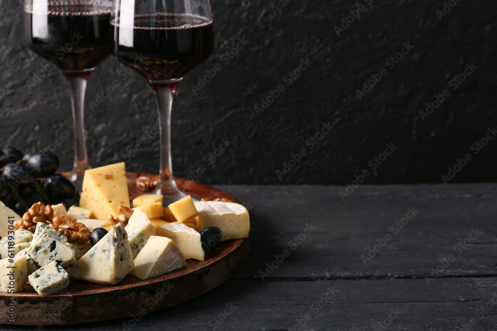 Plate with pieces of tasty cheese on table, closeup