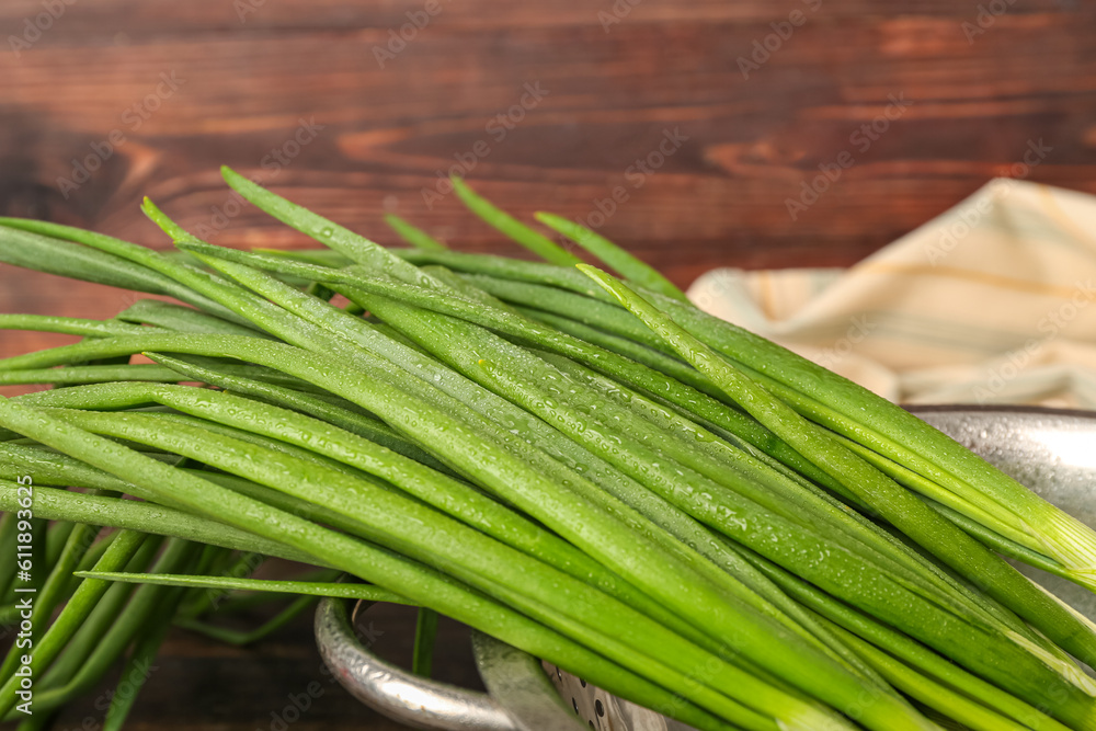 Fresh green onion on wooden background, closeup